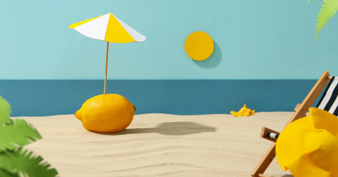 A playful summer scene with a lemon under a beach umbrella – a fun and fresh visual idea for Shopify brands launching seasonal campaigns.