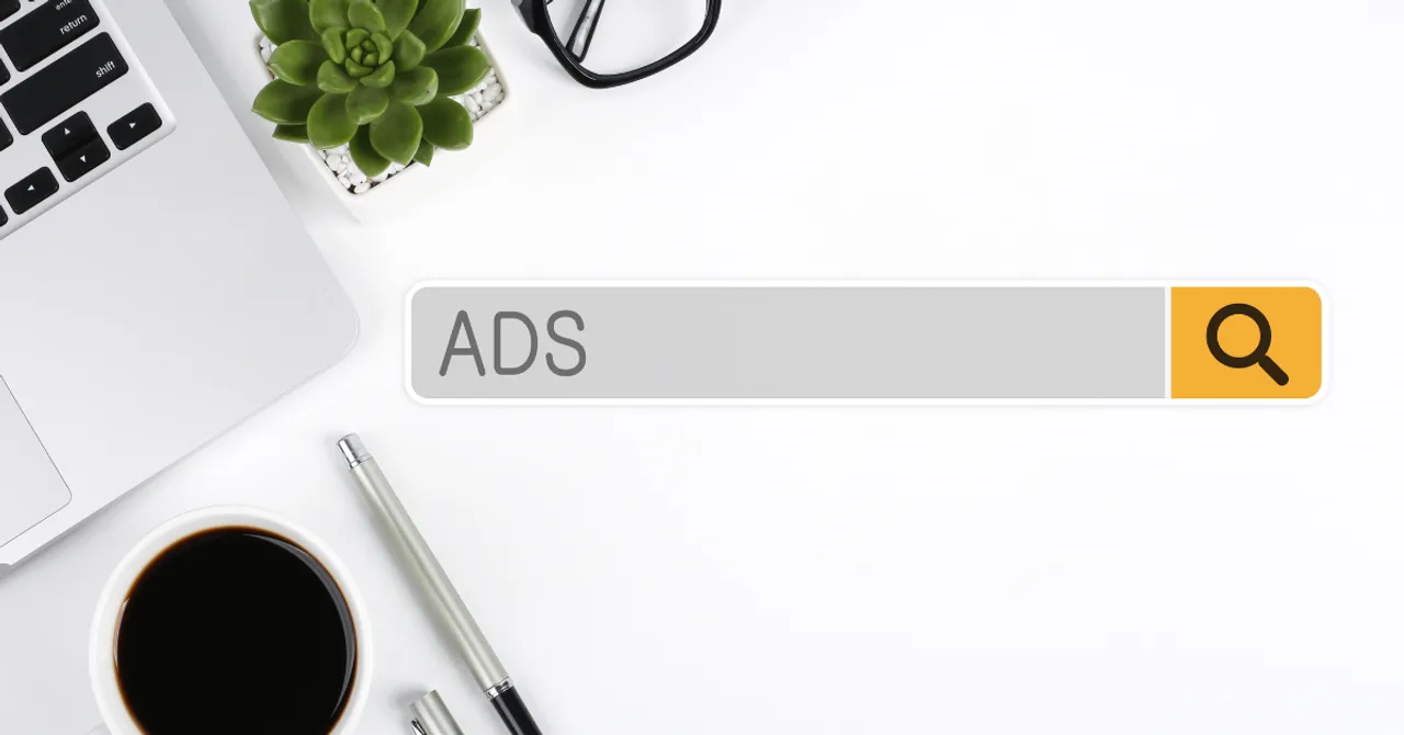 Clean desktop workspace with a search bar showing the word 'ADS' – a minimal visual for Shopify merchants exploring summer advertising strategies.