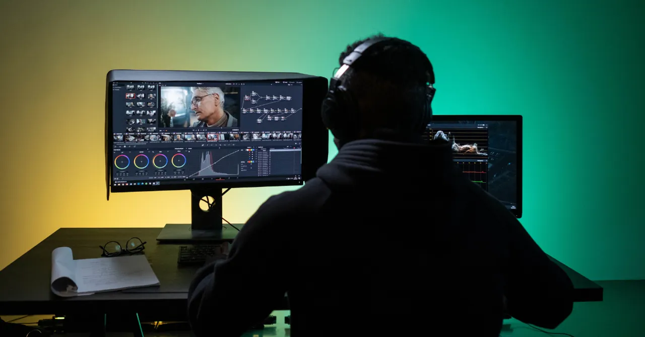 Person editing video content on dual screens, representing how AI tools streamline promo video creation for eCommerce.