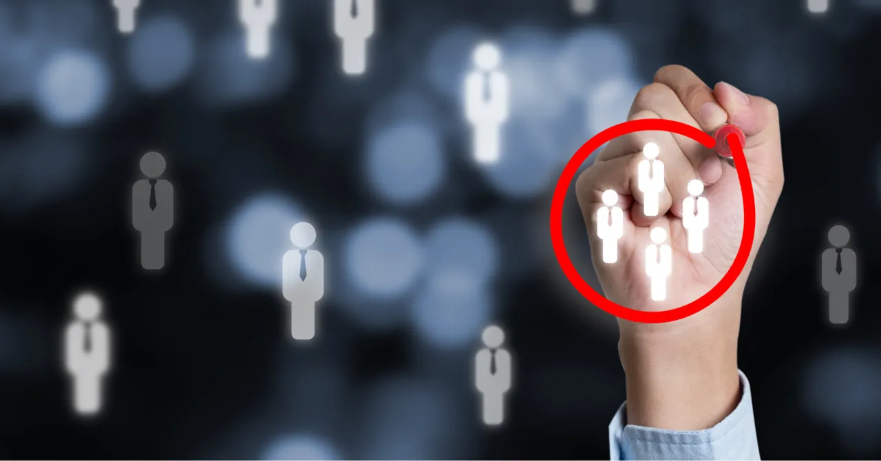 Hand circling a target audience icon, symbolizing personalized marketing and customer segmentation.