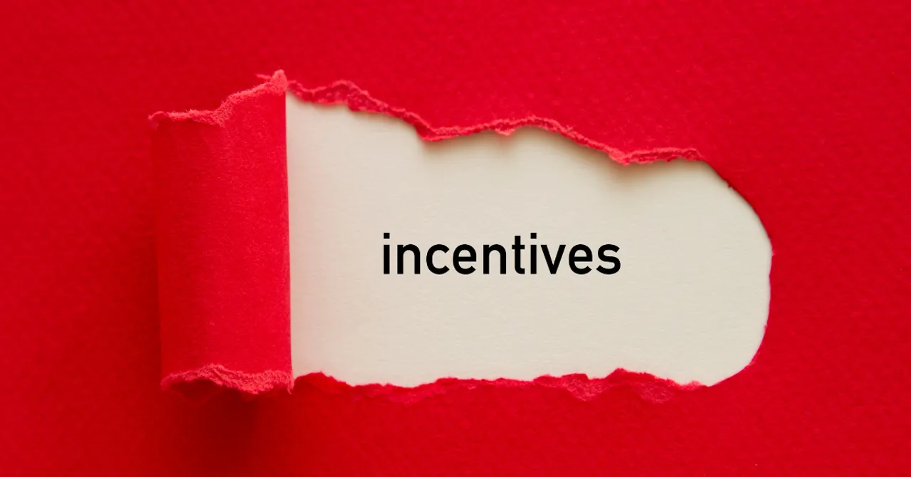 Word ‘incentives’ revealed under torn red paper.