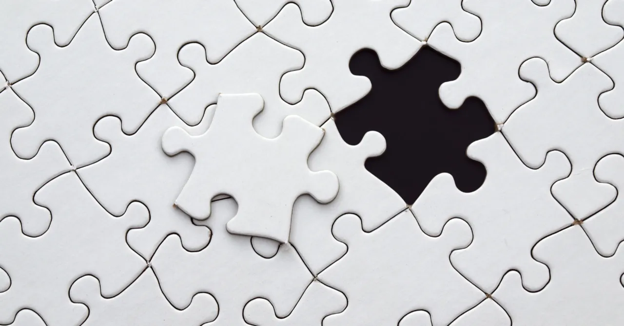 Puzzle piece about to complete the puzzle.