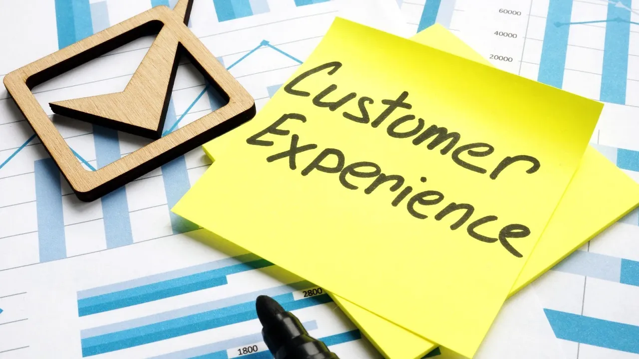 Sticky note labeled "Customer Experience" placed on business analytics documents – highlighting the importance of personalized engagement in loyalty programs.