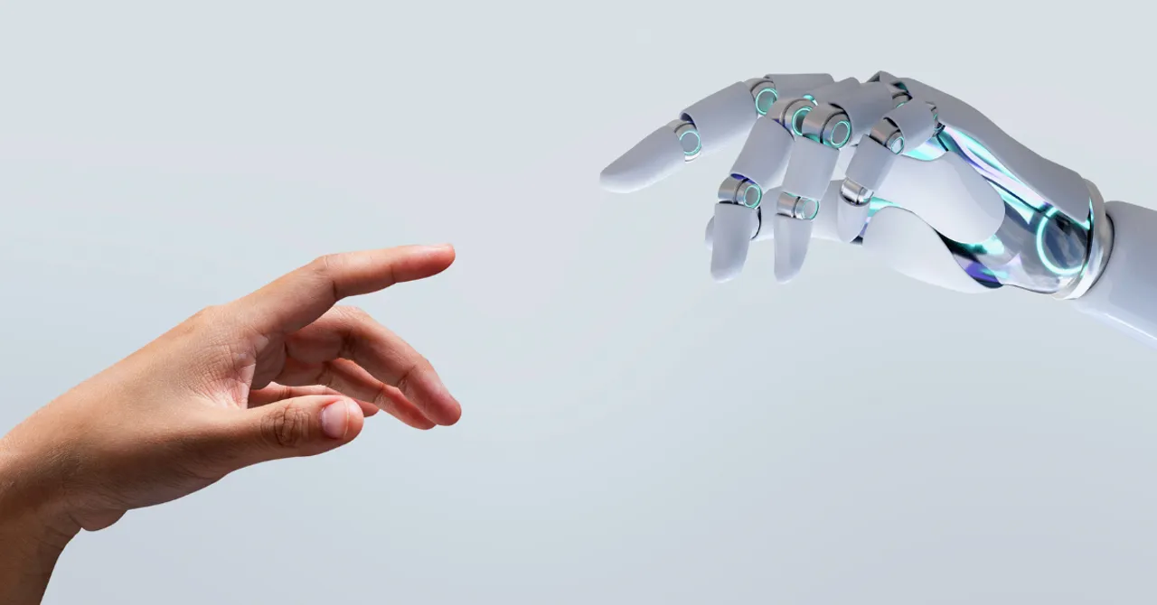A human hand reaching out to a robotic hand — symbolizing the collaboration between AI and people to create smarter, more personalized skincare experiences.
