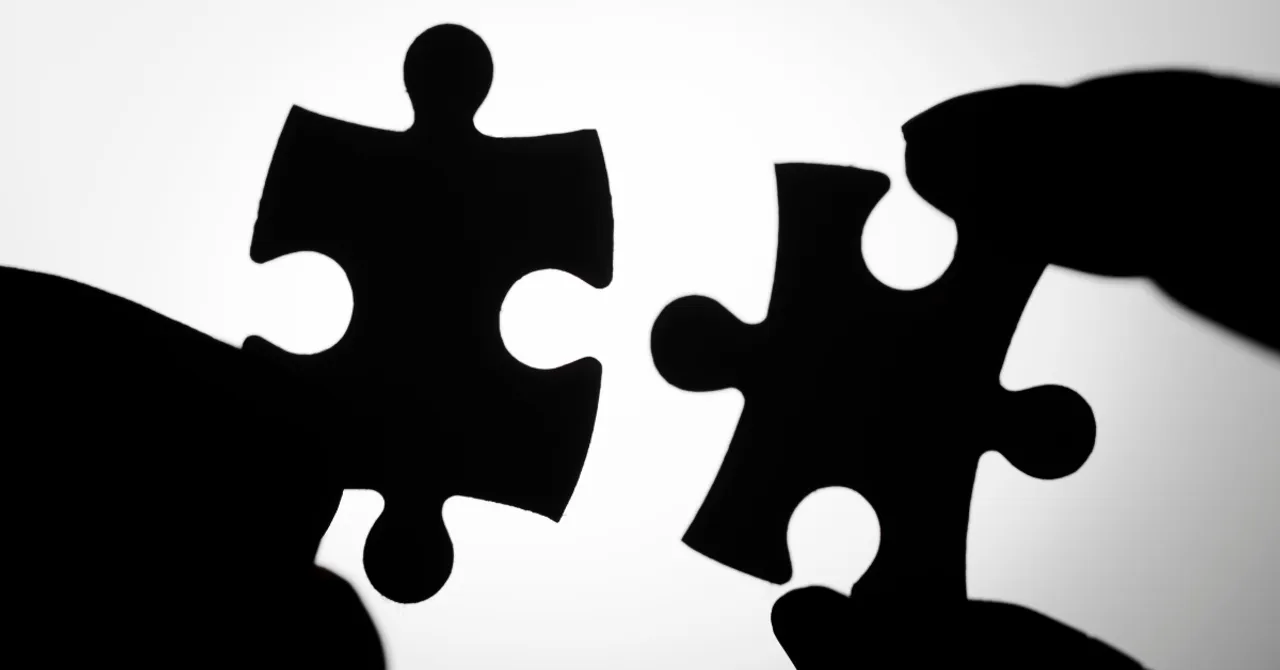 Two puzzle pieces about to connect - symbolizing the perfect match between skincare products and individual skin needs through AI technology.