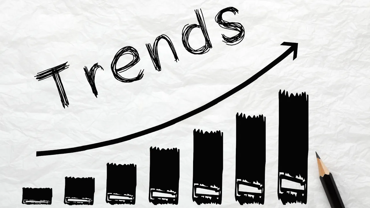 Hand-drawn bar graph with upward arrow and the word "Trends" on crumpled white paper, symbolizing growth and emerging market directions.