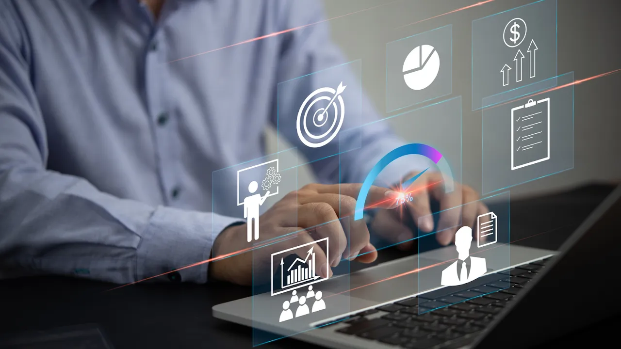 Businessman analyzing marketing performance with futuristic dashboard on laptop screen.