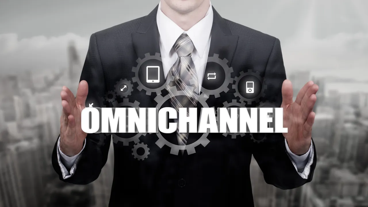 Businessman presenting the concept of omnichannel strategy with digital gear icons representing multiple touchpoints