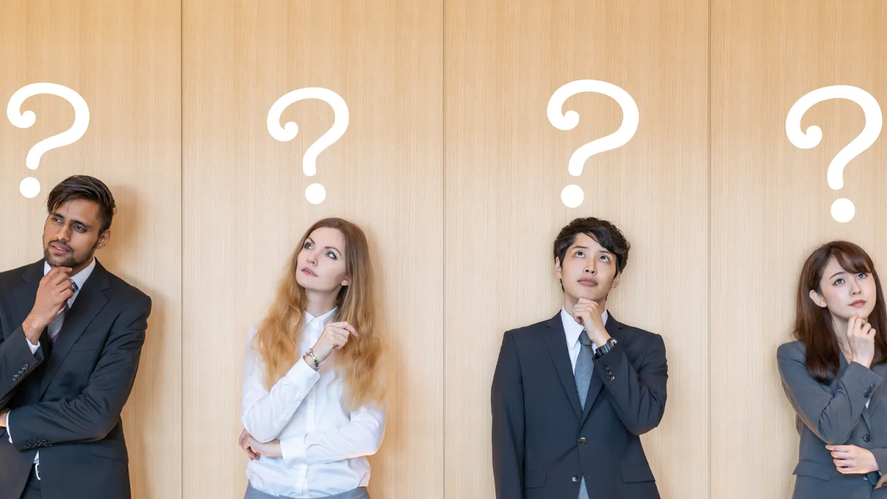 Four business professionals standing thoughtfully with question marks above their heads, symbolizing uncertainty, decision-making, or customer queries in a corporate context.